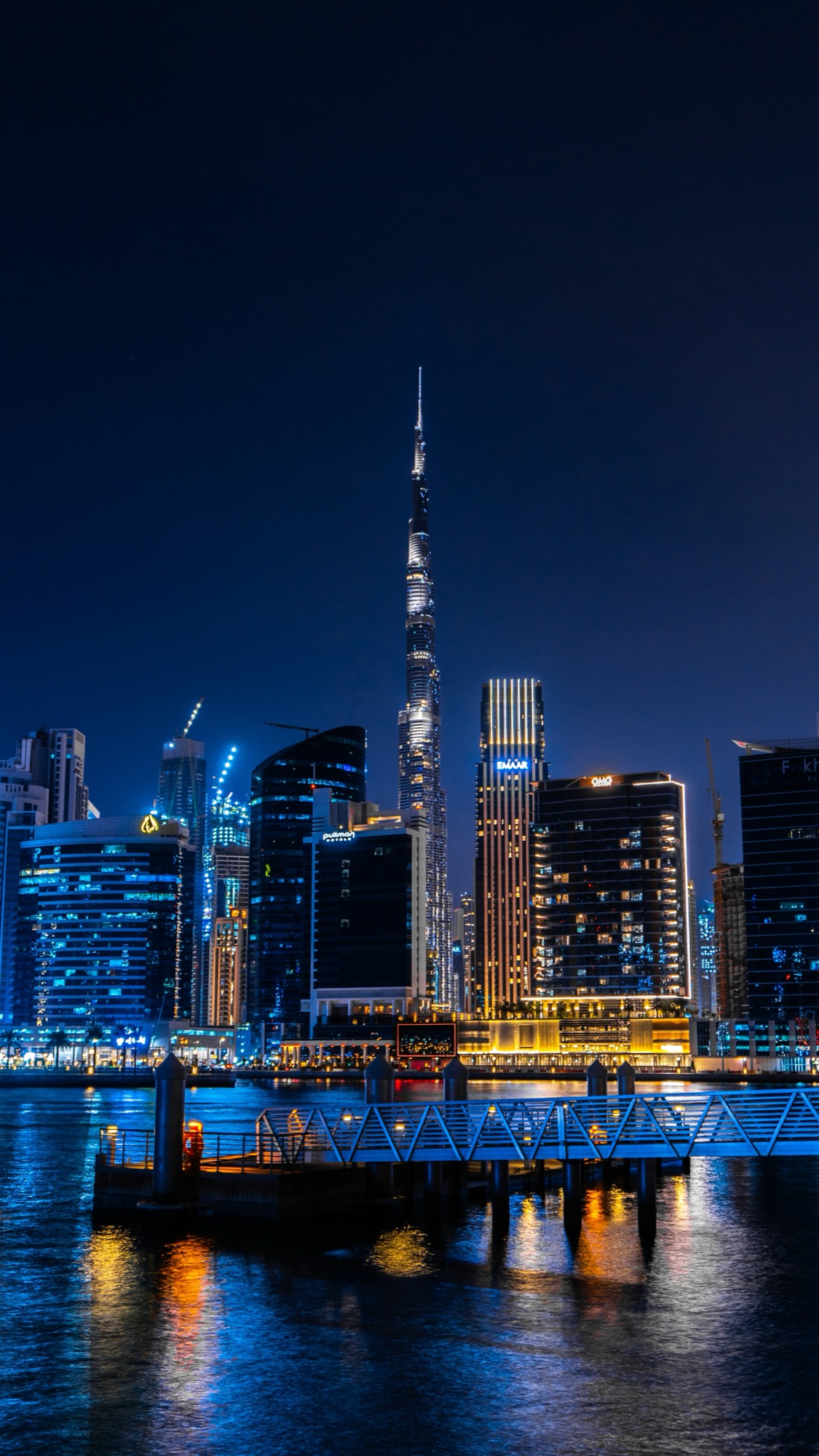 Dubai skyline at sunset with Burj Khalifa and the Sheikh Zayed Road interchange